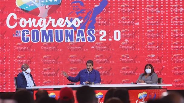 Maduro hablando en el congreso de las comunas junto a dos miembros de su partido.