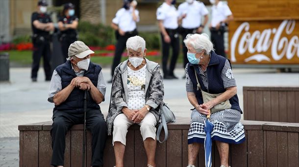 Tres personas mayores conversan, con la mascarilla puesta, en Donostia-San Sebastián.